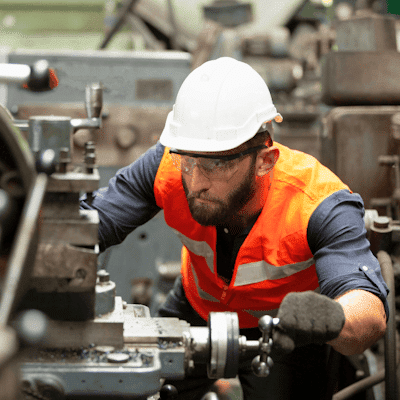 Opérateur concentré travaillant sur une machine industrielle